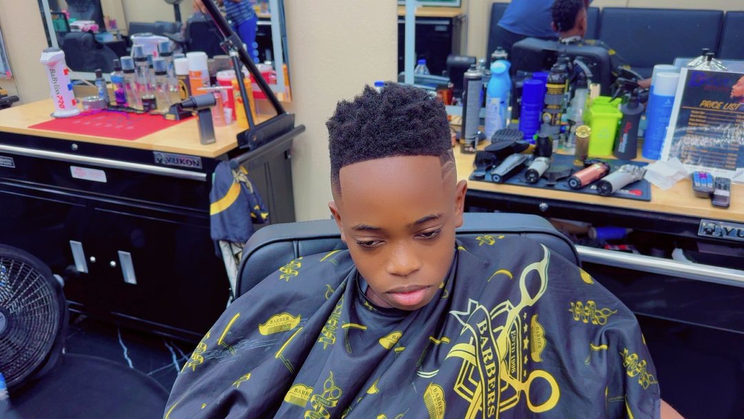Boy with twists on top and a design part