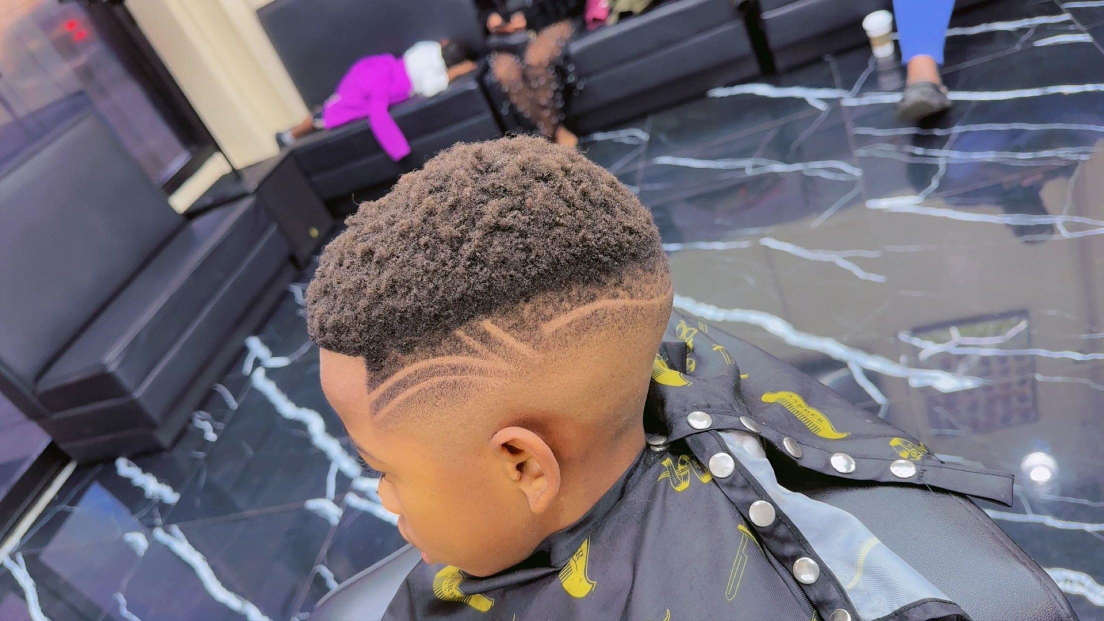 Boy's high-top fade with curved design lines